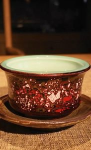 Handmade lacquer tea cup in a calm tea setting