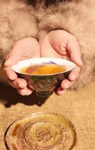 offering tea with both hands as a sign of respect in tea culture