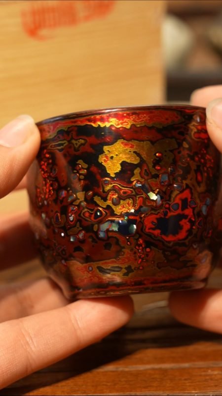 Artisan applying natural lacquer to a handmade Chinese lacquerware vessel in a traditional craft workshop