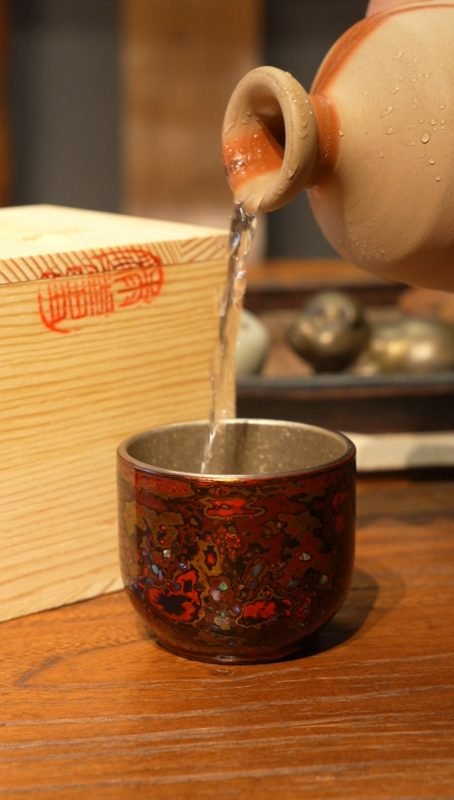 Handmade Chinese lacquer tea ware, wood-fired ceramics, and Yaozhou celadon arranged for everyday tea use