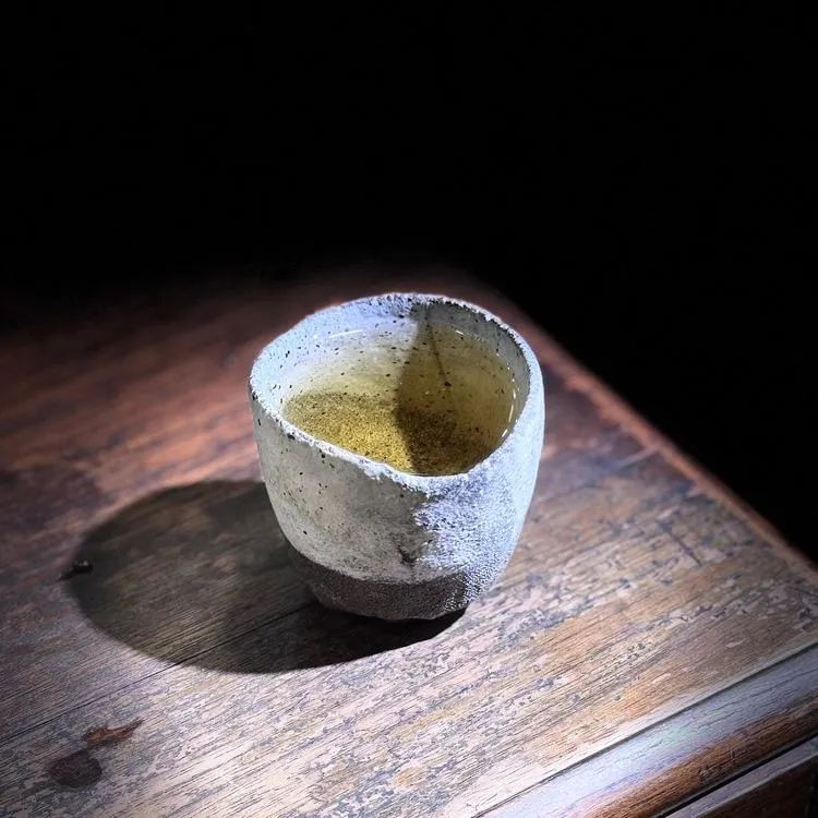 Single handmade vessel displayed quietly in a natural interior without visible branding