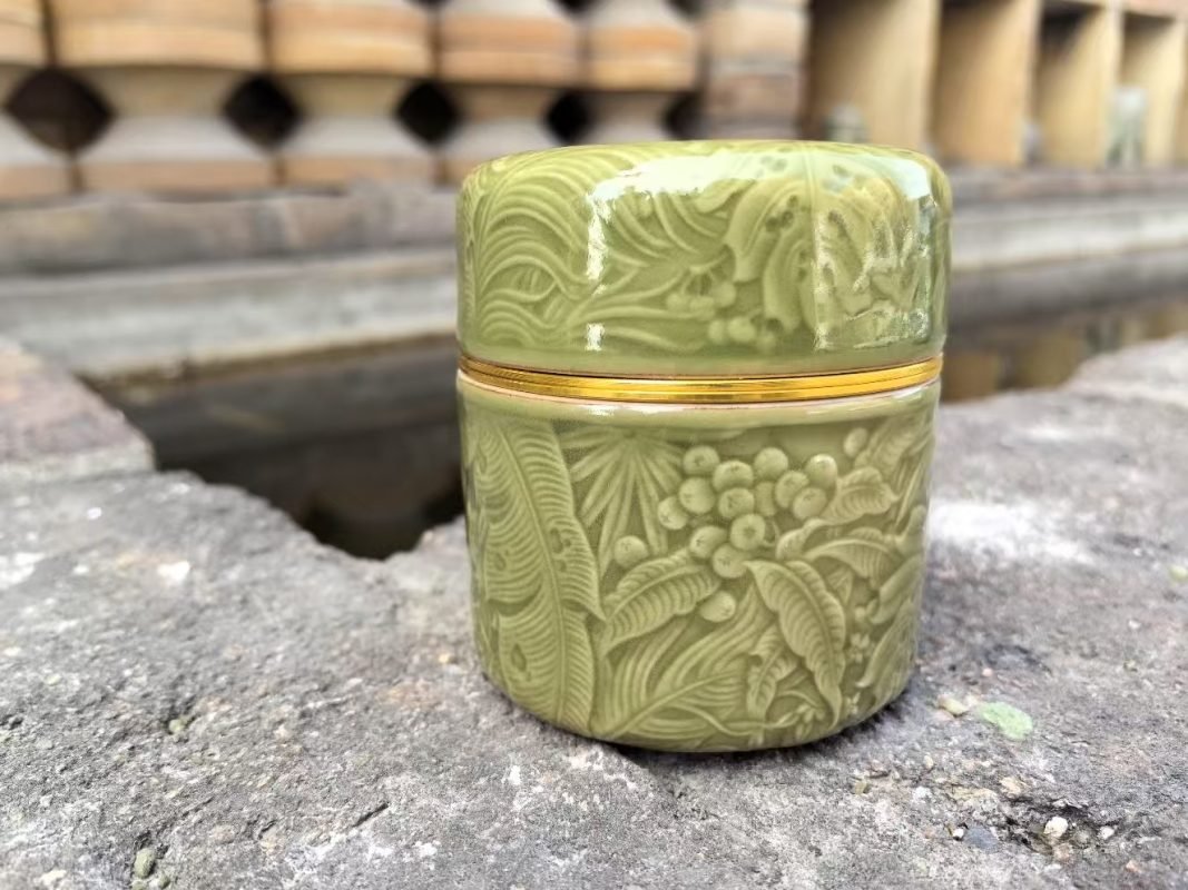 Close-up of a handmade Yaozhou celadon vessel showing its smooth green glaze