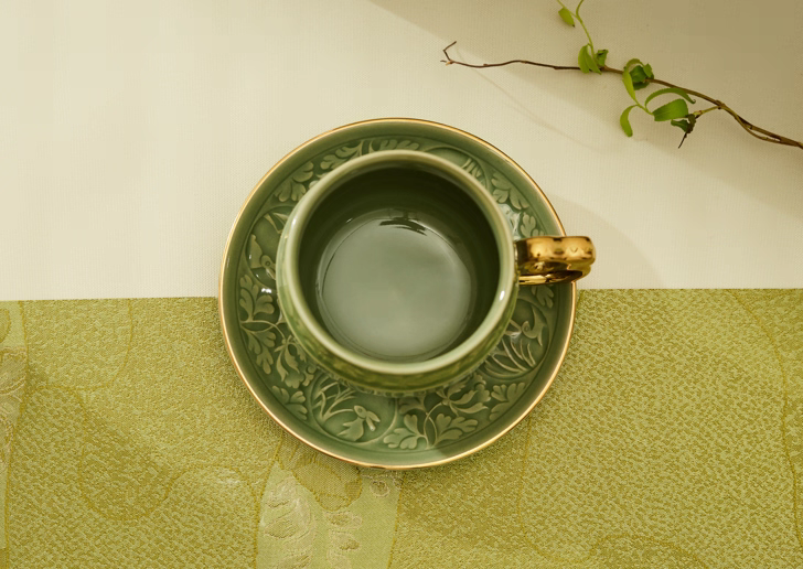 Carved rabbit motif on celadon porcelain cup detail