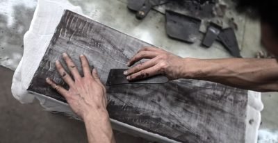 artisan applying cloth layer to lacquerware base