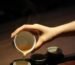 Warm tea being poured into a handmade ceramic tea cup