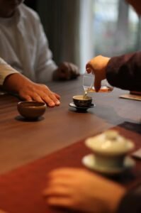pouring tea for another person as a gesture of attention and connection