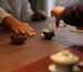 pouring tea for another person as a gesture of attention and connection