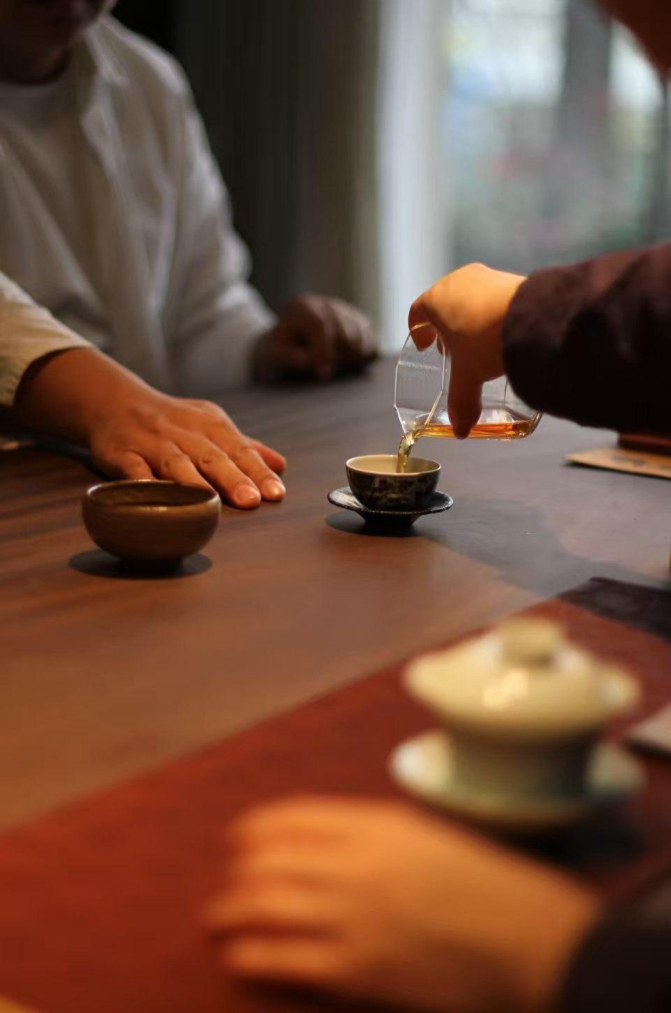 pouring tea for another person as a gesture of attention and connection