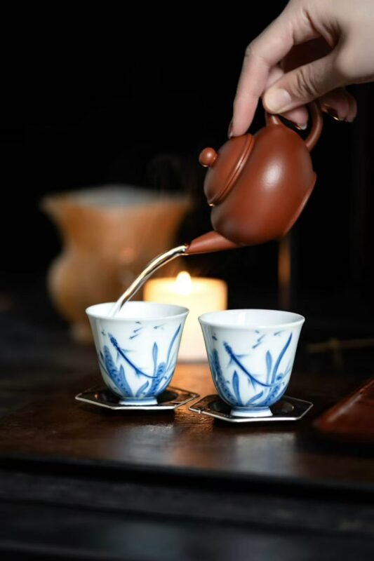 pouring hot water over tea leaves in a slow and intentional brewing process