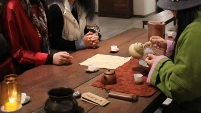 people sharing tea in a quiet social setting with calm and focused conversation