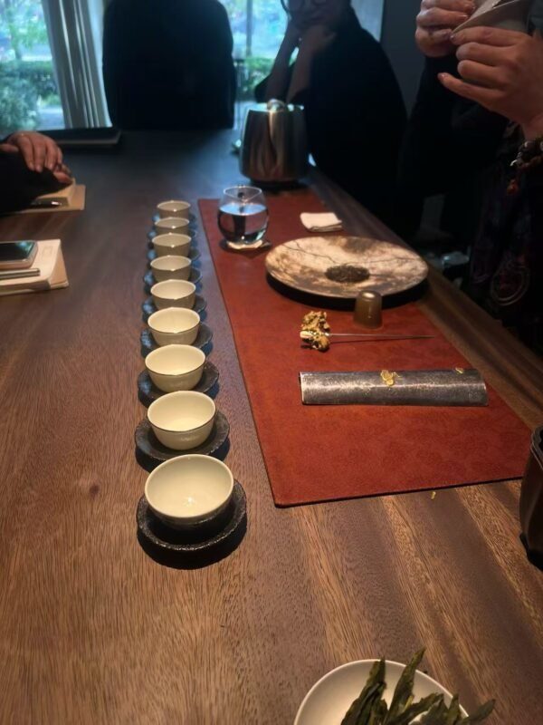 Person holding a handmade tea vessel naturally during a quiet tea ritual at home