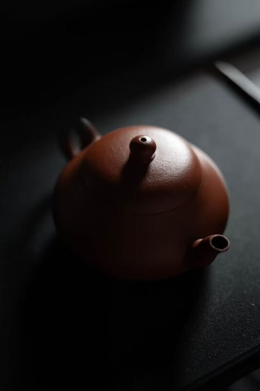 Handmade ceramic tea pot in a quiet shadowed space