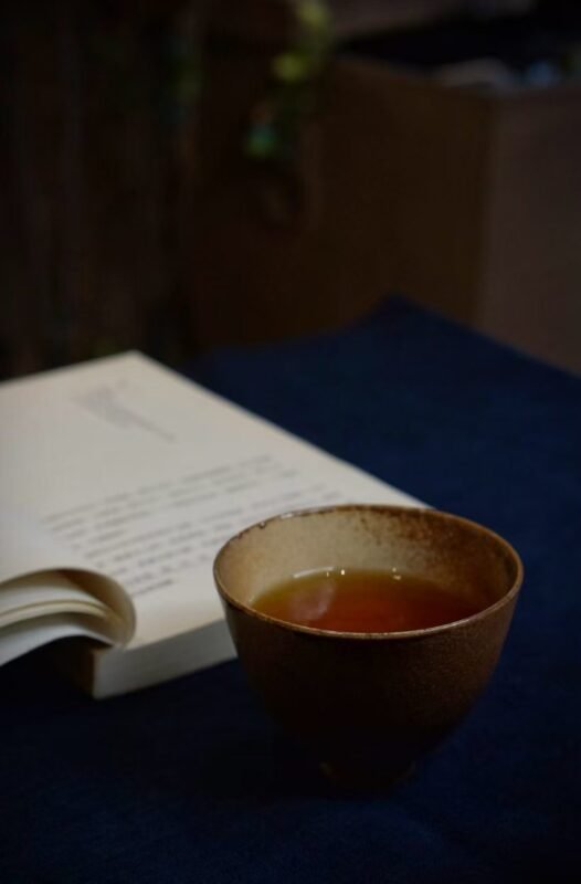 Quiet tea moment beside a window with handmade ceramic tea ware