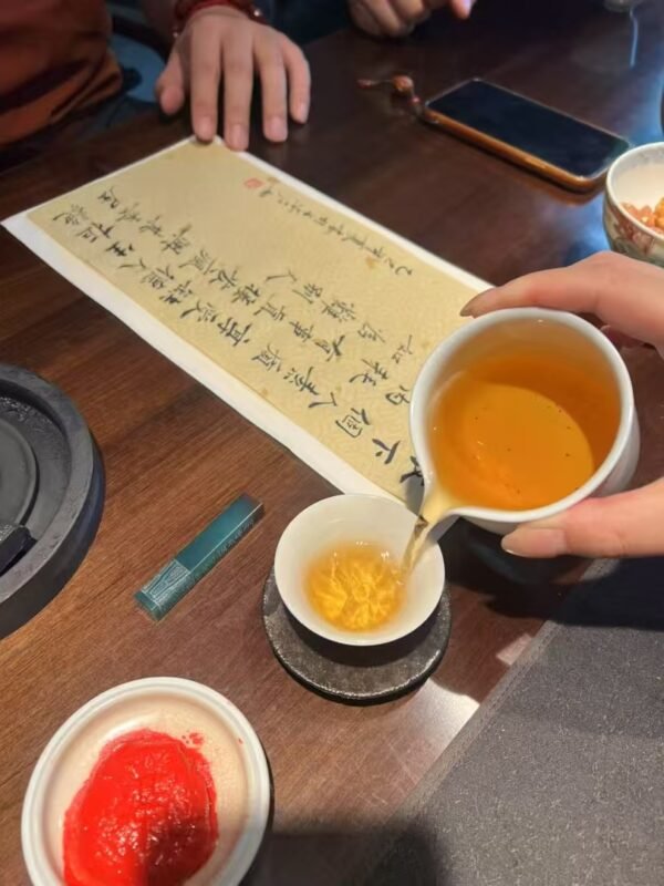 Hand holding handmade tea cup as a personal ritual object connected with daily attention and presence