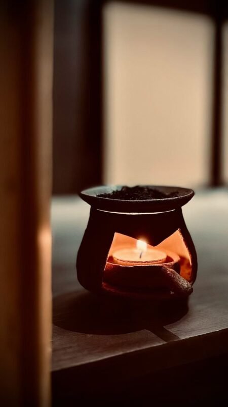 Minimal tea and incense setup creating calm atmospheric space