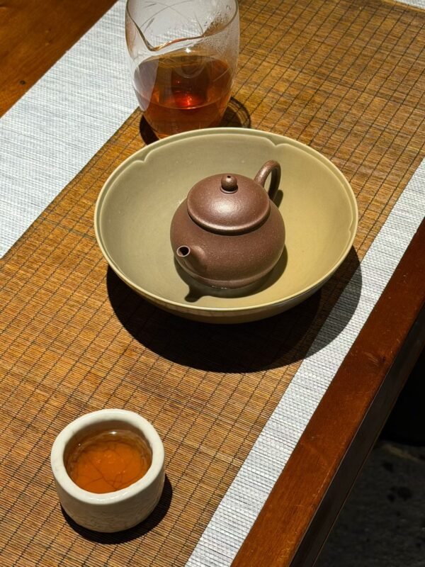 Soft green celadon tea ware in natural morning light