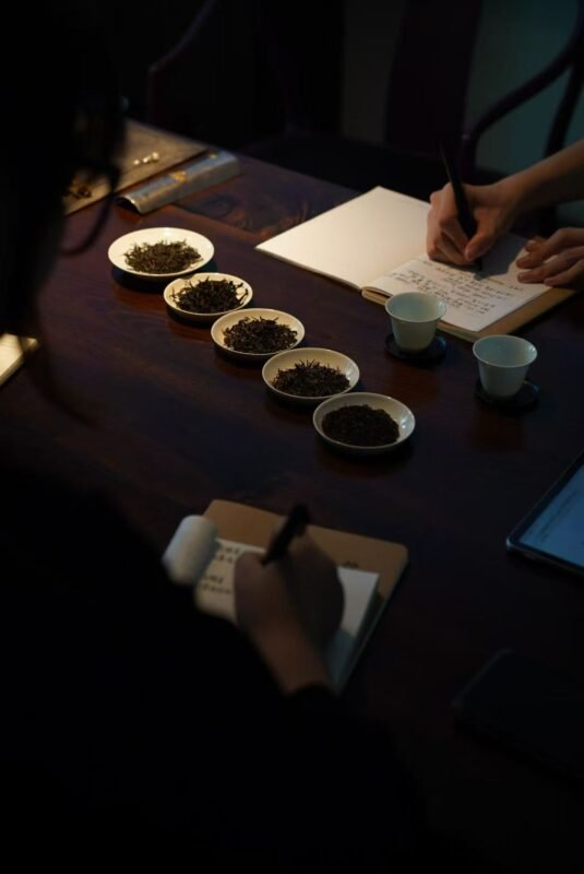 Scholar writing beside tea cup in calm study room atmosphere