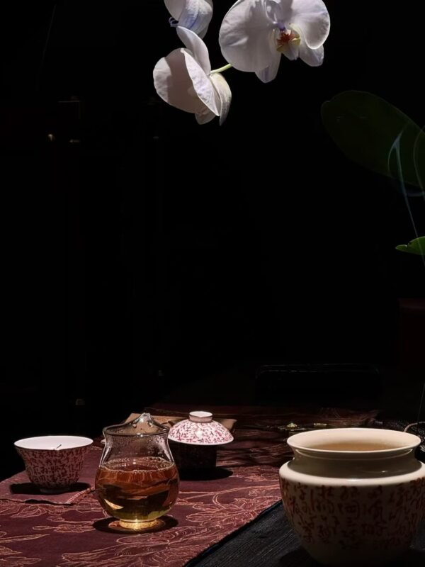 Steaming tea cup on wooden table in quiet night atmosphere