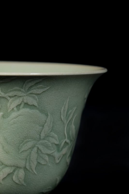 Close view of handmade tea bowl showing texture and curved rim