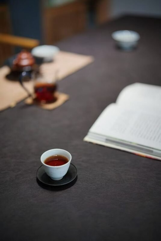 Close view of scholar desk with tea cup brush and paper in calm setting