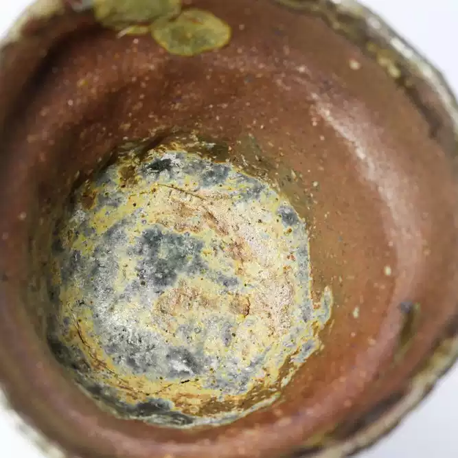 Close detail of uneven glaze on a handmade ceramic tea bowl