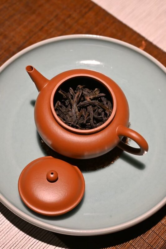 Celadon tea ware creating a calm atmosphere on a wooden tea table