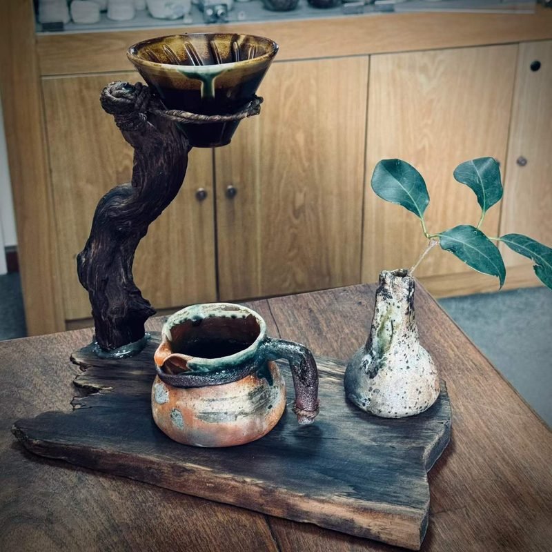 Fresh filter coffee served in a handmade ceramic mug beside a glass pour-over server